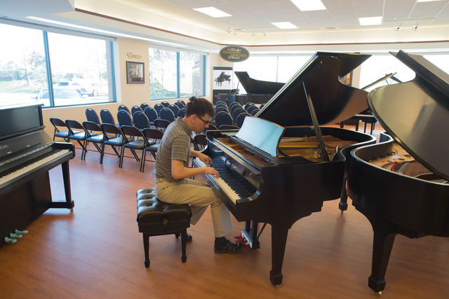 A picture of a man playing piano