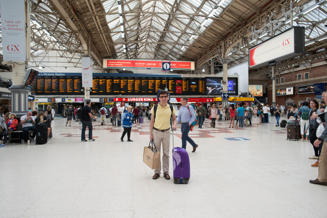 A picture of a man standing in Victoria station main hall
